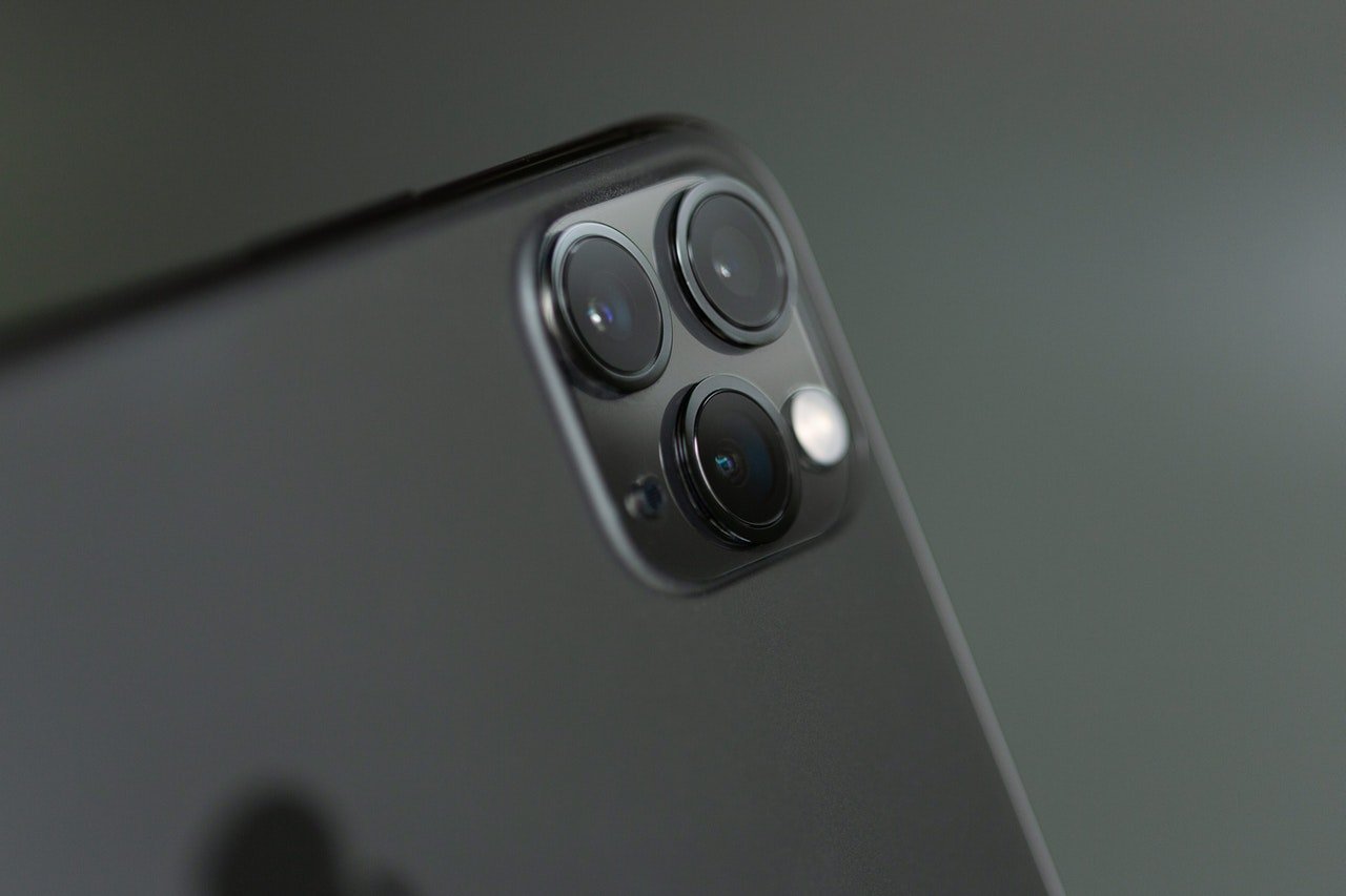 How do phone skins help to protect the camera lens?