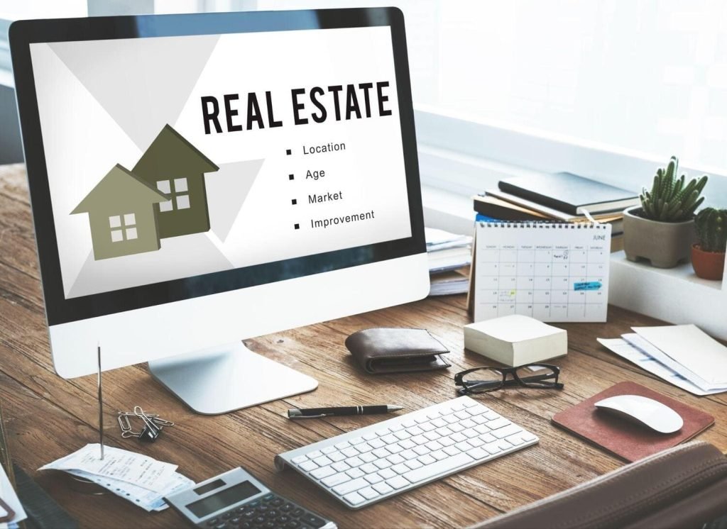 An image of a laptop screen displaying the words 'Real Estate'